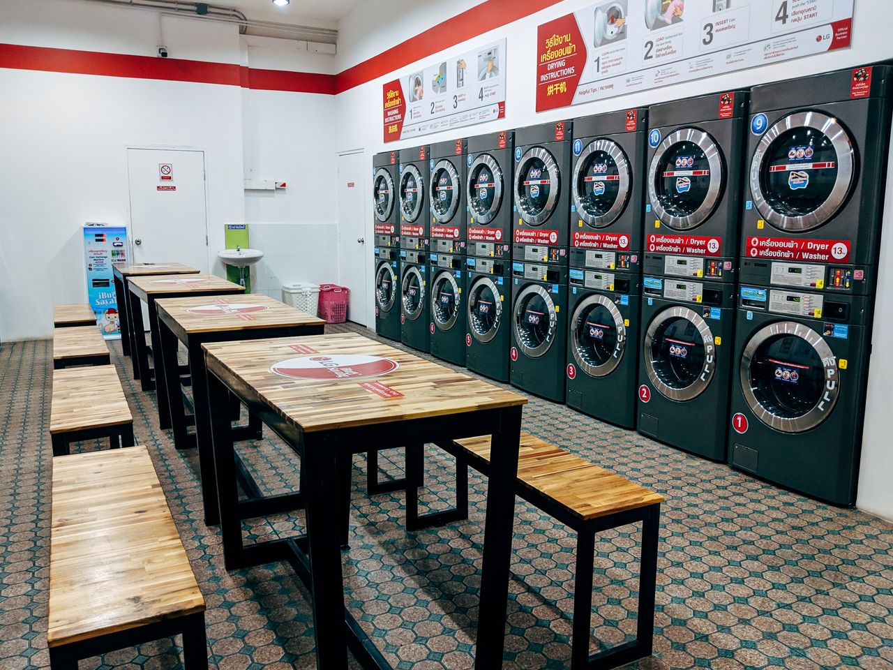 Spacious laundromat with multiple washing machines and seating area for convenience.